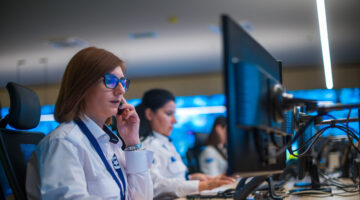 Female,security,guard,sitting,and,monitoring,modern,cctv,cameras,in