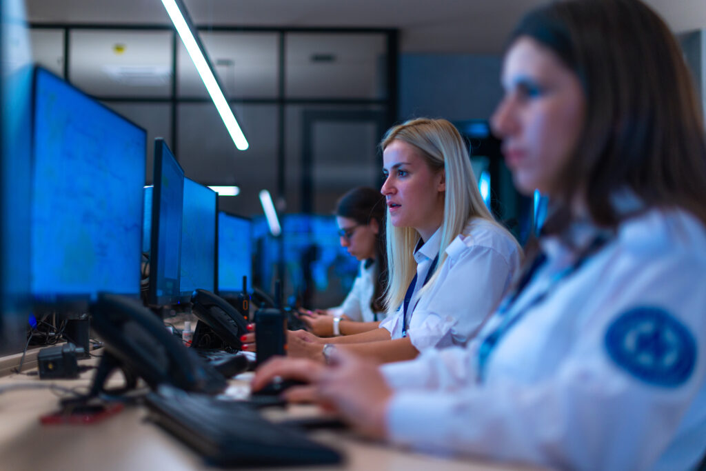 Happy,security,data,center,operator,colleagues,(coworkers),smiling,and,monitoring